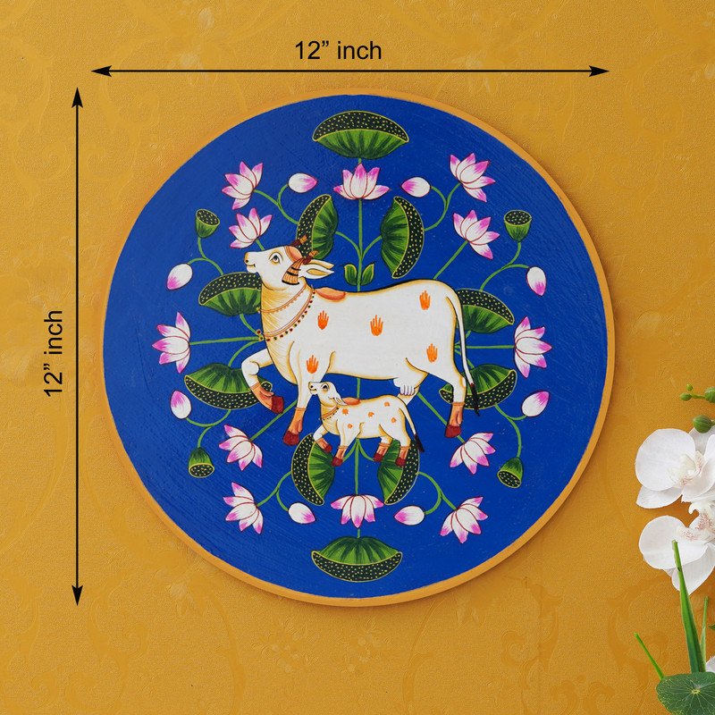 This beautiful pichwai painting features a mother cow and her calf nuzzling each other, surrounded by a vibrant array of flowers.