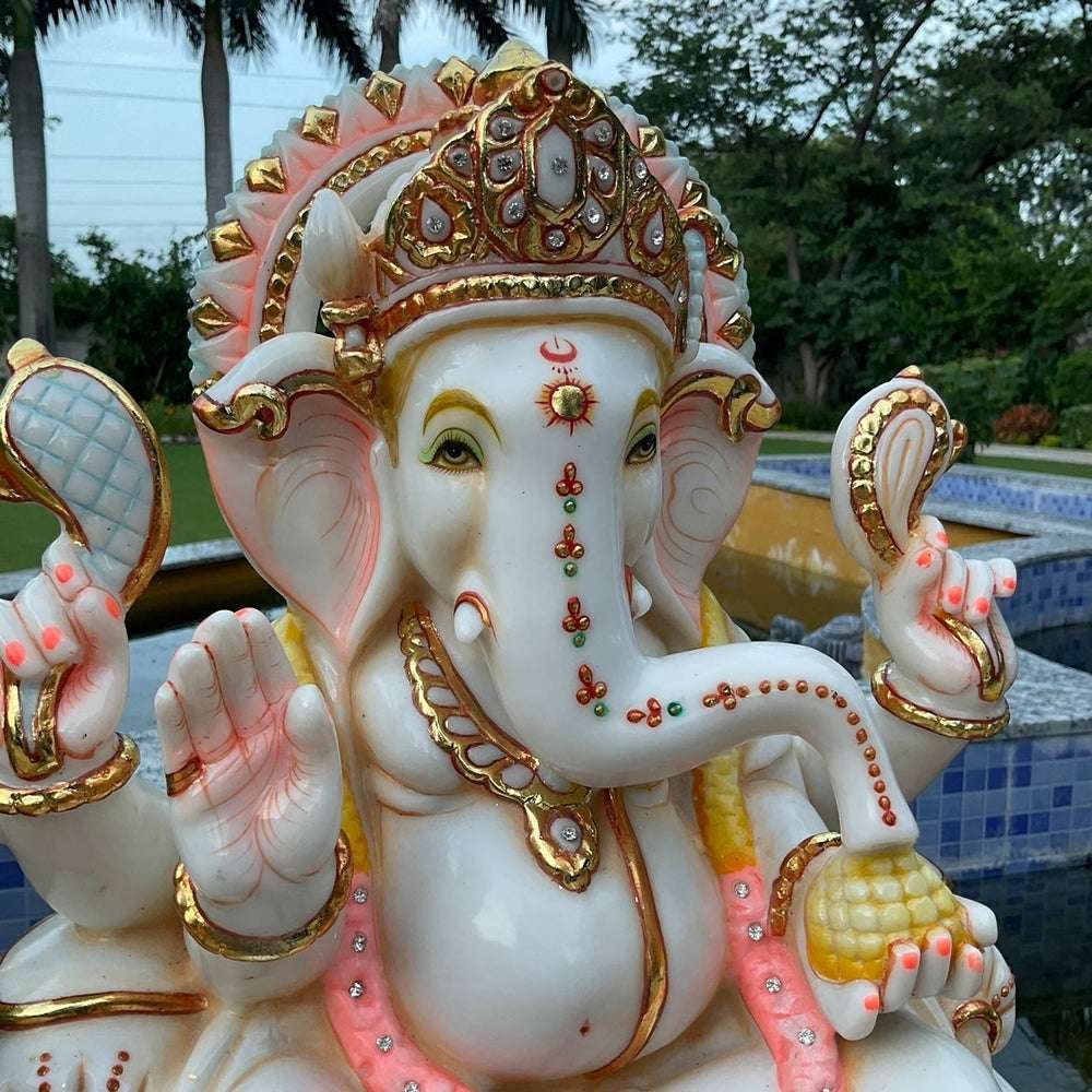 Royal Ganesha Seated on Lotus with Modaks and Golden Ornaments Marble Showpiece