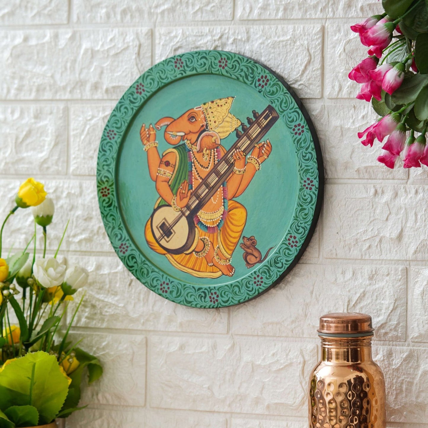 This beautiful pichwai painting features a majestic ganesh ji perched on a vibrant flowering branch.