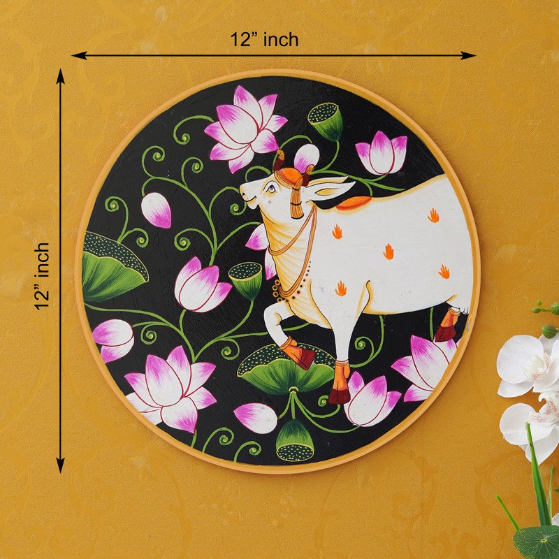 This beautiful pichwai painting features a serene white cow adorned with a vibrant floral headdress.