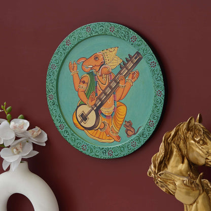 This beautiful pichwai painting features a majestic ganesh ji perched on a vibrant flowering branch.